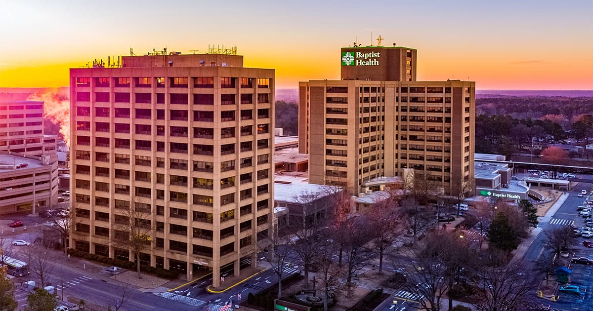 The sun rises behind Baptist Health Medical Center in Little Rock, Arkansas