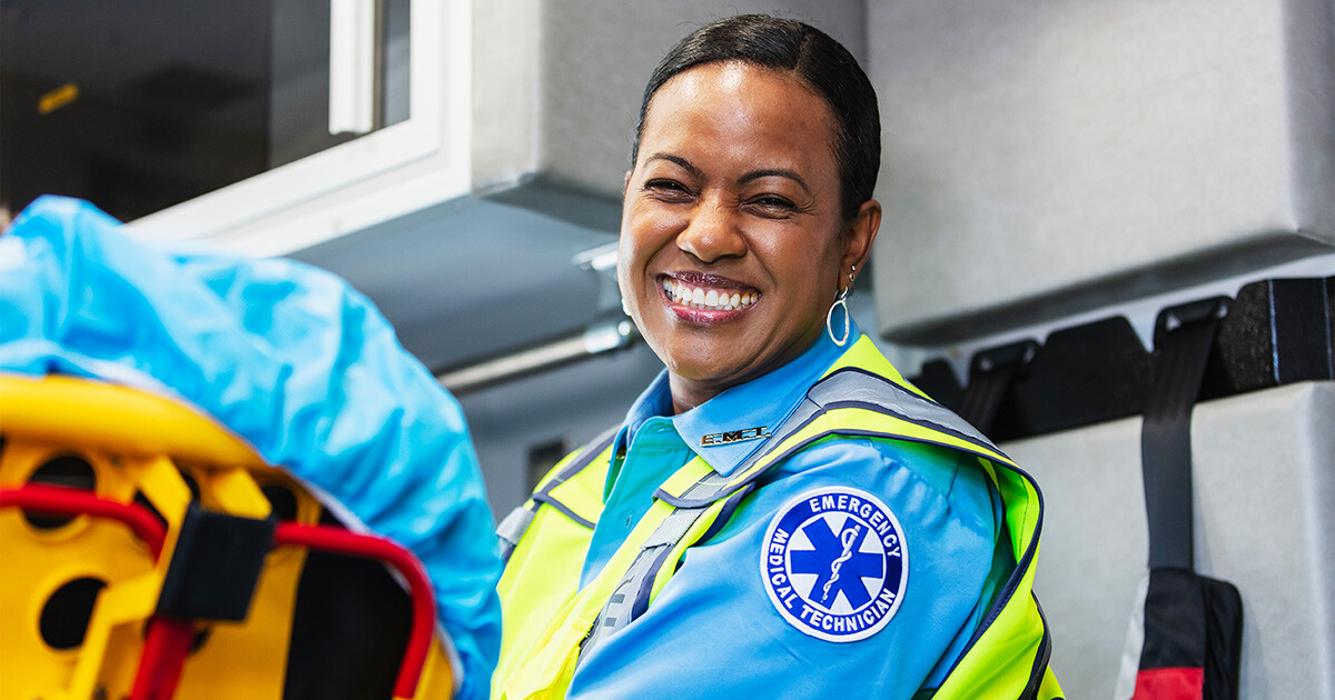 an emt smiles at the camera